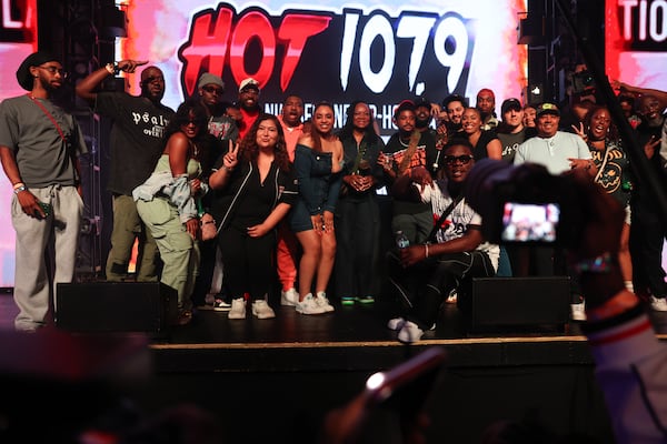 Hot 107.9 staff gather for a photo on stage at the Who’s Hot Showcase at Believe Music Hall. (Arvin Temkar/AJC)