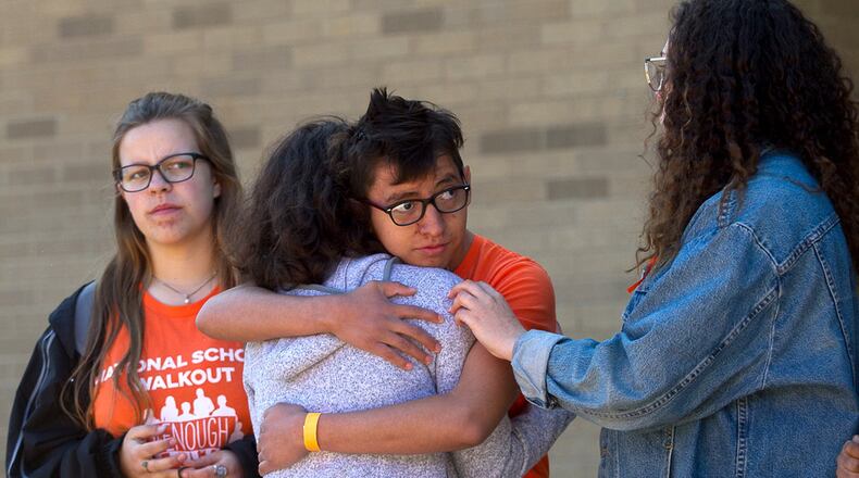 Lakeside High School student Roni Wagner gives Leah Weiss a hug after Weiss gave an emotional speech during National Walkout day in Atlanta on Friday, April 20, 2018. STEVE SCHAEFER / SPECIAL TO THE AJC