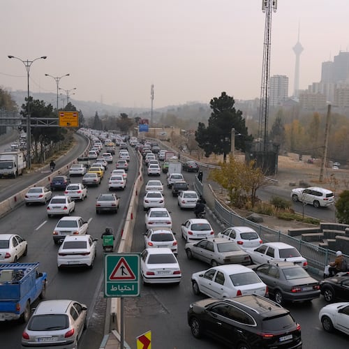 Cars drive in an afternoon traffic jam in a high air pollution in Tehran, Iran, Sunday, Dec. 7, 2025. (AP Photo/Vahid Salemi)