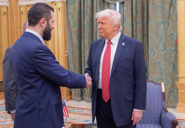 In this photo released by the Saudi Royal Palace, President Donald Trump, right, shakes hands with Syria's interim President Ahmad al-Sharaa, in Riyadh, Saudi Arabia, Wednesday, May 14, 2025. (Bandar Aljaloud/Saudi Royal Palace via AP)