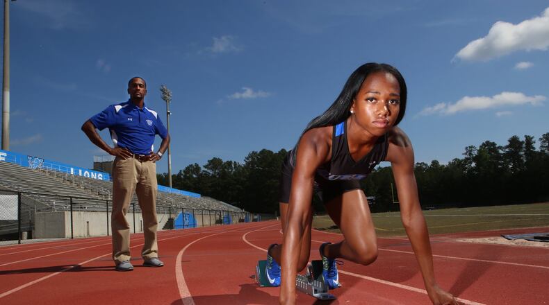 Kennedy Simon (right), a junior, and Robert Wilson (left), the head track coach, pose for a portrait at Westlake High School in Atlanta, Georgia, on May 18, 2017. Simon recently placed first in the long jump, 400m dash, and 200m dash at the 2017 GHSA Track and Field State Championships and is looking at the University of Georgia, Tennessee, and Miami as possible college destinations. (HENRY TAYLOR / HENRY.TAYLOR@AJC.COM)