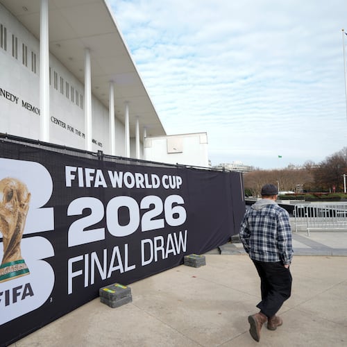 A man walks past signage prior to the final draw for the 2026 soccer World Cup at the Kennedy Center in Washington, Thursday, Dec. 4, 2025. (AP Photo/Chris Carlson)