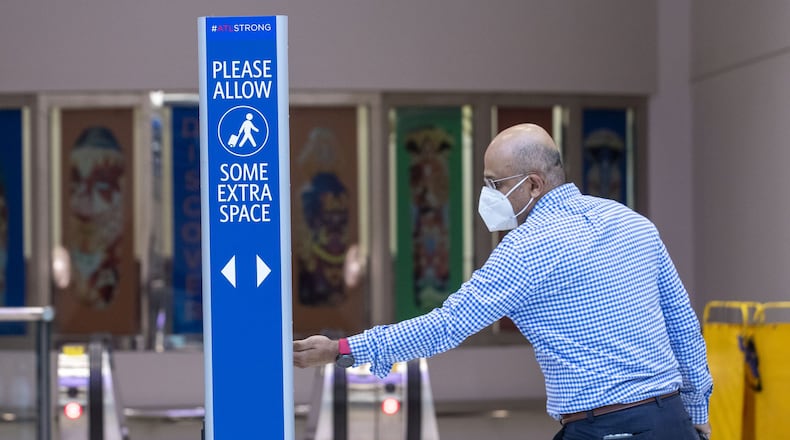 A man uses a hand sanitizing station located in the domestic terminal at Hartsfield-Jackson International Airport in Atlanta, Wednesday, May 20, 2020. (ALYSSA POINTER / ALYSSA.POINTER@AJC.COM)
