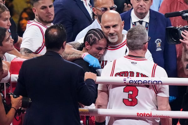 Puerto Rico's Amanda Serrano is comforted by her team after losing to Ireland's Katie Taylor after a super lightweight championship boxing match Saturday, July 12, 2025, in New York. (AP Photo/Frank Franklin II)