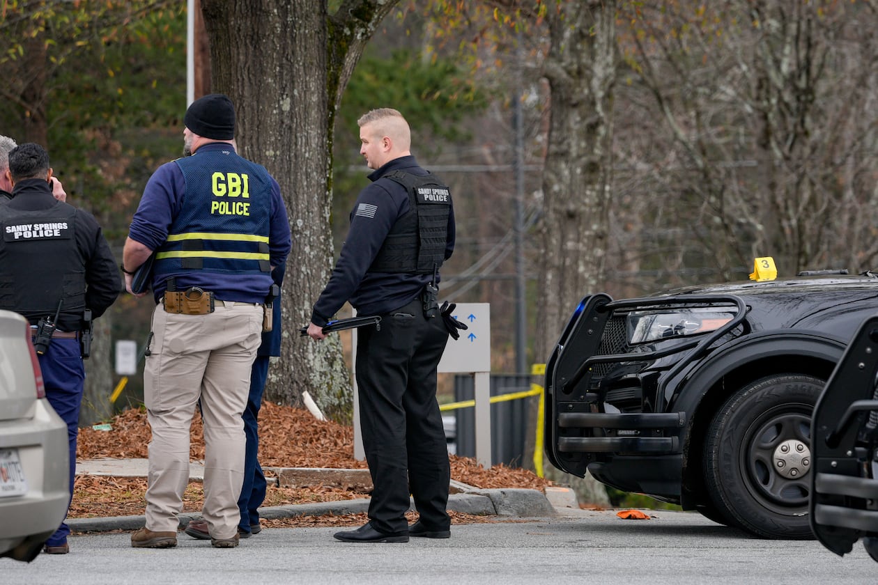 Sandy Springs officers respond to a police shooting in the area of Roswell Road and Dunwoody Place on Thursday. (Ben Hendren for the AJC)