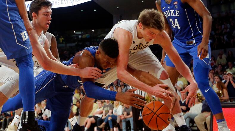 Duke forward Javin DeLaurier, center left, battles Georgia Tech's Ben Lammers, center right, and Evan Cole, back left, for the ball in the second half of an NCAA college basketball game Sunday, Feb. 11, 2018, in Atlanta. (AP Photo/John Bazemore)