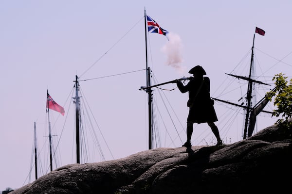 A Colonial soldier fires on the British during a reenactment in celebration of the 250th anniversary of the Battle of Bunker Hill, Saturday, June 21, 2025, in Gloucester, Mass. (AP Photo/Charles Krupa)