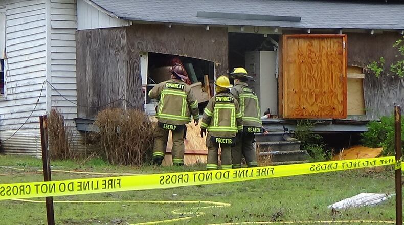 Gwinnett County firefighters examine a house in unincorporated Loganville that burned Saturday morning. A 76-year-old man died in the fire. (Credit: Gwinnett Fire and Emergency Services)