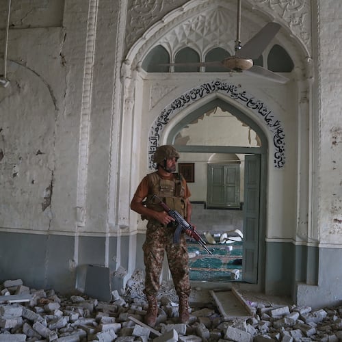 An Army soldier walks over rubble at the site of a bomb explosion at a mosque in Kohat, in northwestern Pakistan, Friday, Sept. 18, 2026. (AP Photo/Muhammad Sajjad)