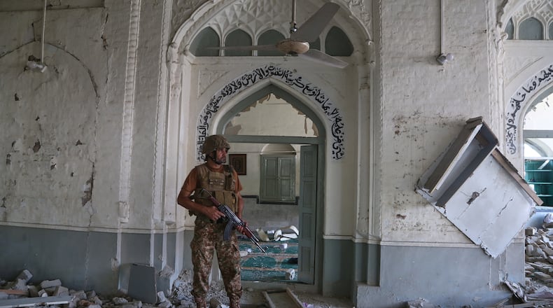An Army soldier walks over rubble at the site of a bomb explosion at a mosque in Kohat, in northwestern Pakistan, Friday, Sept. 18, 2026. (AP Photo/Muhammad Sajjad)