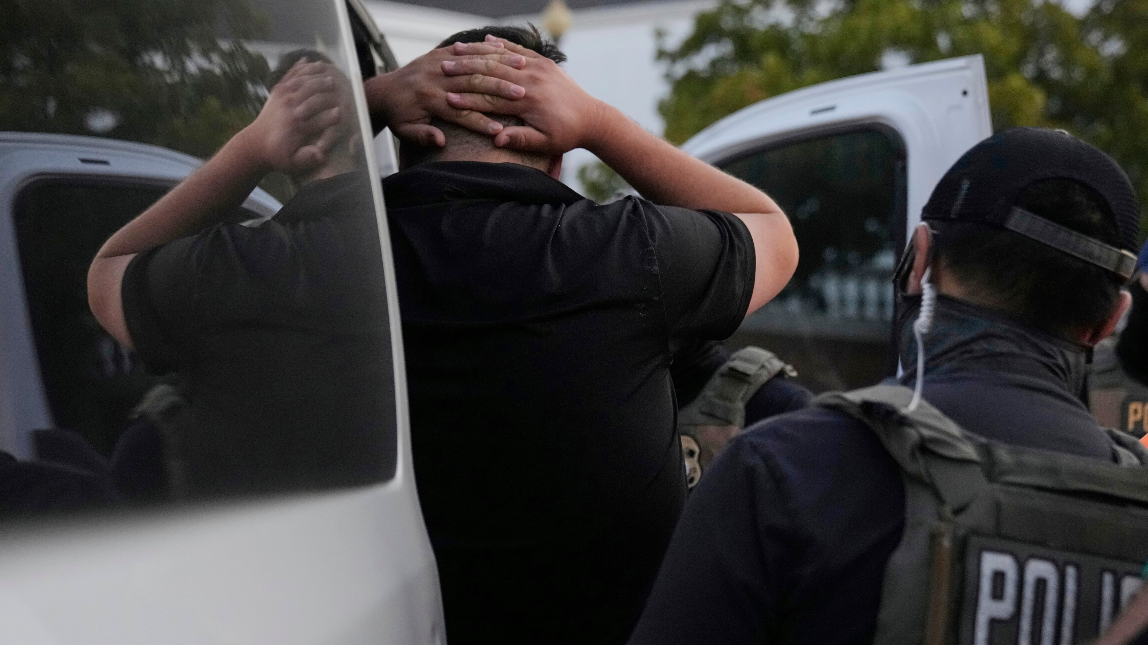 U.S. Immigration and Customs Enforcement agents make an arrest during an early morning operation in Park Ridge, Ill., Friday, Sept. 19, 2025. (AP Photo/Erin Hooley)