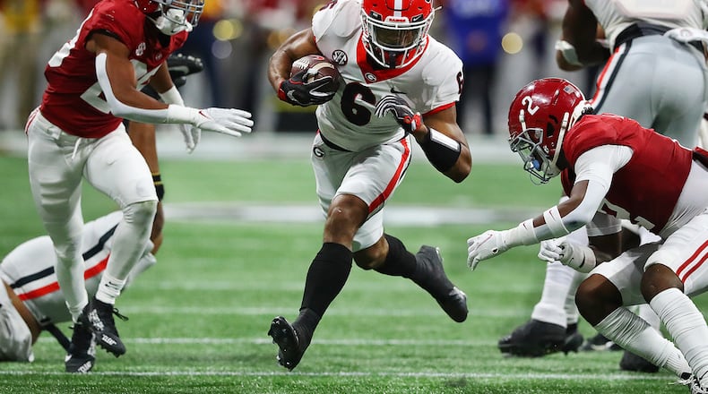Georgia running back Kenny McIntosh finds some running room between Alabama defenders during the second half in the SEC Championship game on Dec 4 in Atlanta. (Curtis Compton / Curtis.Compton@ajc.com)