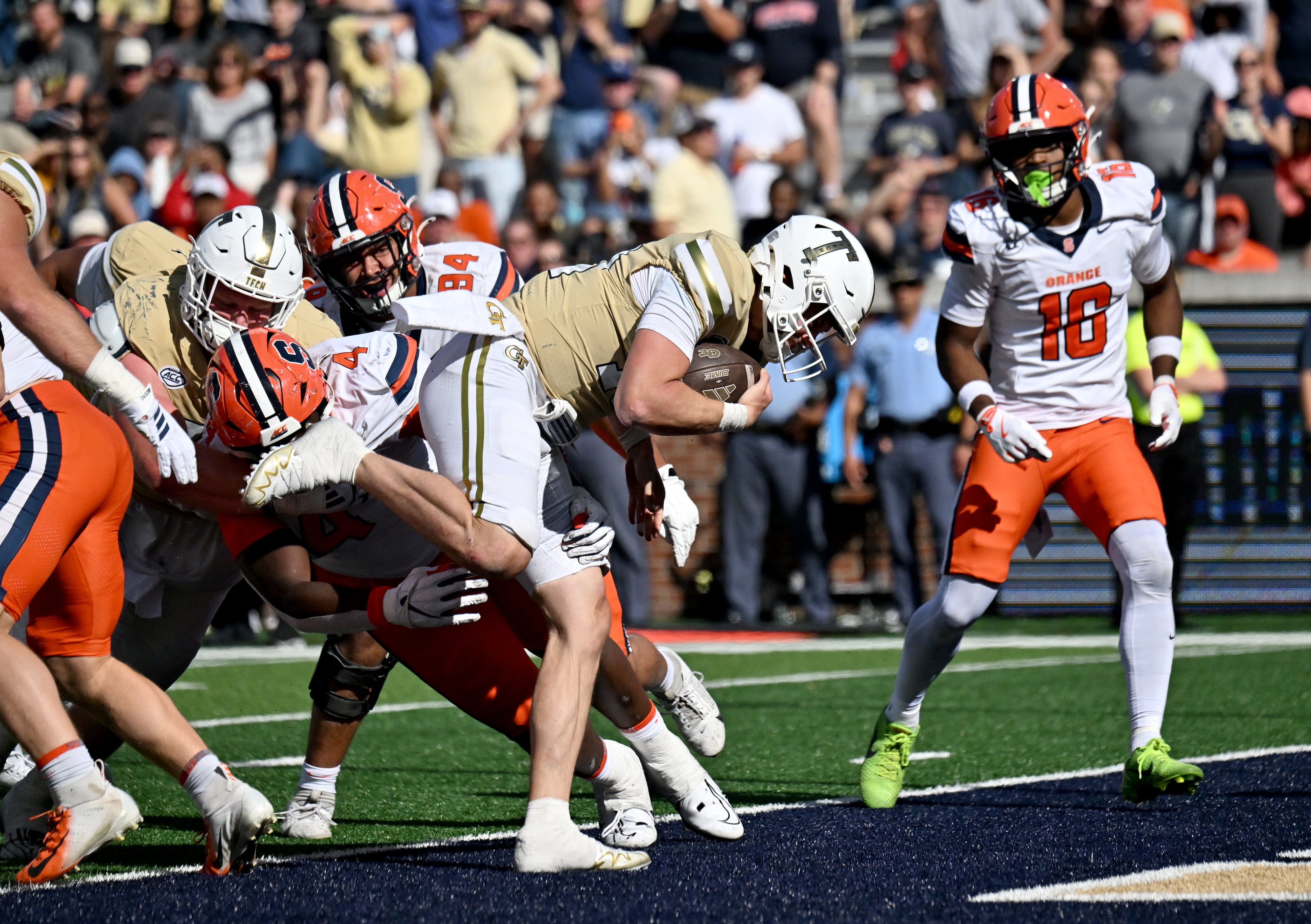 Georgia Tech quarterback Haynes King (second from right) pushes through for a touchdown during the second half in an NCAA college football game at Bobby Dodd Stadium, Saturday, Oct. 25, 2025 in Atlanta. Georgia Tech won 41-16 over Syracuse. The Yellow Jackets are 8-0 for the first time since 1966 and 5-0 in the ACC for the first time ever. (Hyosub Shin/AJC)