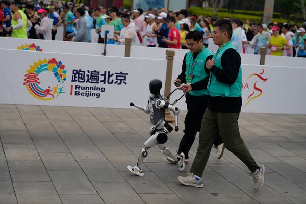 A robot takes part in what is billed as the world's first robot half marathon during the Humanoid Robot Half-Marathon held in Beijing on Saturday, April 19, 2025. (AP Photo/Ng Han Guan)