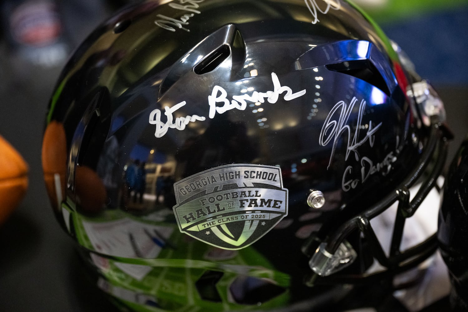 Signatures of inductees are seen on a helmet during the Georgia High School Football Hall of Fame induction ceremony Saturday, Oct. 25, 2025, at the College Football Hall of Fame in Atlanta. (Daniel Varnado for the AJC)