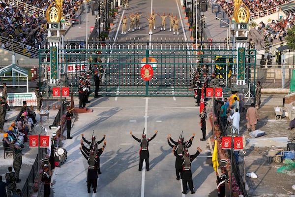 Pakistan's Rangers soldiers, bottom, and Indian Border Security Forces soldiers, top, parade during a daily closing ceremony at the Wagah, a joint post on the Pakistan and India border, near Lahore, Pakistan, Monday, May 5, 2025. (AP Photo/K.M. Chaudary)