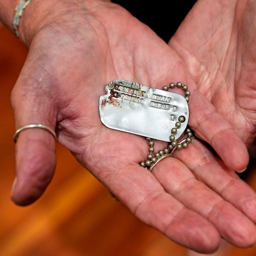 FILE- Diane Christie holds a recovered dog tag belonging to her uncle, World War II U.S. Army Air Forces 2nd Lt. Thomas Kelly, Friday, May 23, 2025, in San Leandro, Calif. (AP Photo/Godofredo A. Vásquez)
