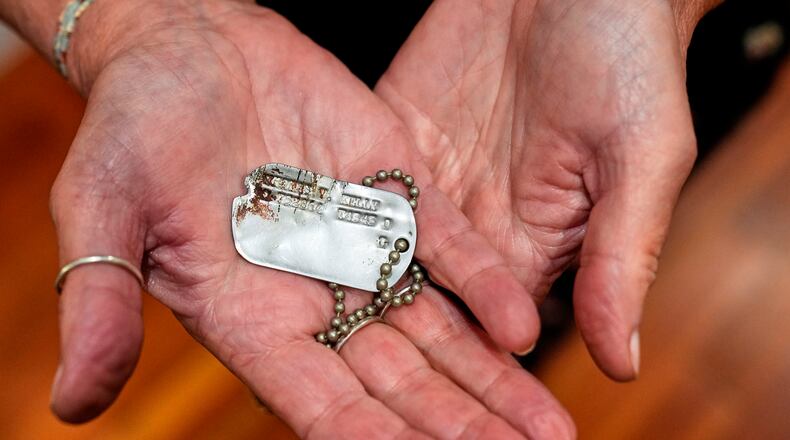 FILE- Diane Christie holds a recovered dog tag belonging to her uncle, World War II U.S. Army Air Forces 2nd Lt. Thomas Kelly, Friday, May 23, 2025, in San Leandro, Calif. (AP Photo/Godofredo A. Vásquez)