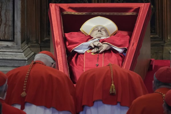 Cardinals pay their respects to Pope Francis inside St. Peter's Basilica at the Vatican, Wednesday, April 23, 2025, where his body will lie in state for three days. (AP Photo/Andrew Medichini, Pool)