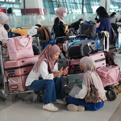 People wait as flights are disrupted due to the eruption of Mount Anak Krakatau, at Soekarno-Hatta International Airport in Tangerang, Indonesia, Monday, Sept. 7, 2026. (AP Photo/Tatan Syuflana)