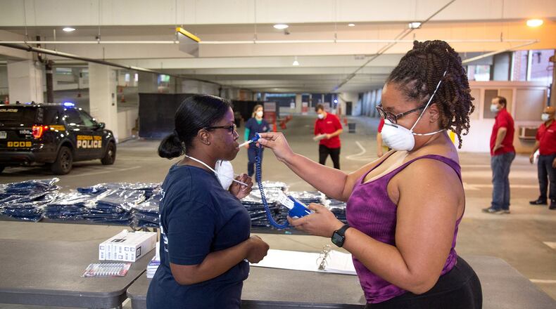 CVS nurses Sharing Neal and Alicia Robinson go through the steps to check-in in preparation for the opening of the COVID-19 drive-through testing center in Atlanta, April 6, 2020.  STEVE SCHAEFER / SPECIAL TO THE AJC