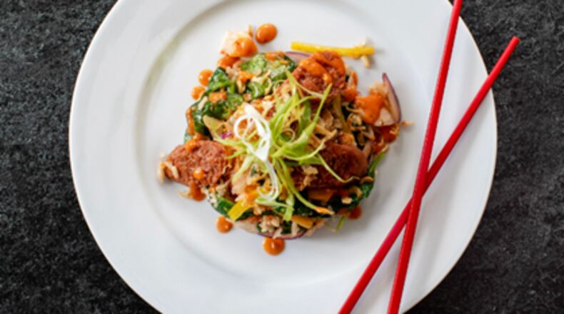 The Cuban bowl from Stir House comes with jasmine rice with chorizo tofu crumble, garlic, onions, black beans, charred corn, sweet peppers, and jalapenos and topped with fried oyster mushrooms and Green Goddess sauce. / Courtesy of Stir House