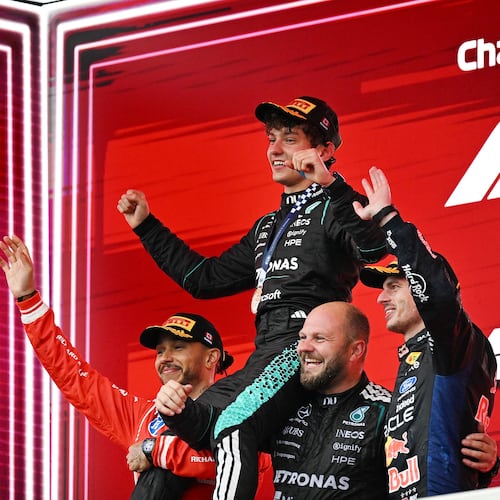 First-place finisher Mercedes driver Kimi Antonelli, top, of Italy, is held aloft by second-place finisher Ferrari driver Lewis Hamilton, left, of Britain, and Mercedes senior composite technician Dean Hale, second from right, as third-place finisher Red Bull Racing driver Max Verstappen, right, of the Netherlands, joins them following the F1 Canadian Grand Prix auto race in Montreal, Sunday, May 24, 2026. (Graham Hughes/The Canadian Press via AP)