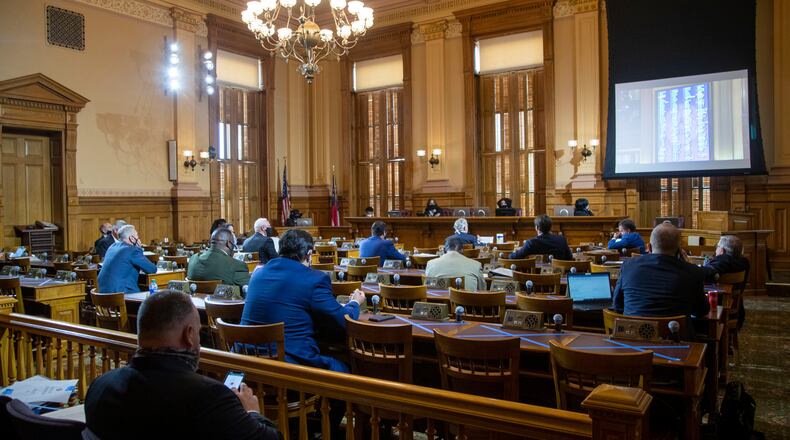 06/15/2020 - Atlanta , Georgia - Members of the Georgia House of Representatives watch their peers work out of the House chamber as they live stream the session from the Senate Committee Room during the 30th day of the legislative session at the Georgia State Capitol building, Monday, June 15, 2020. Due to COVID-19 restrictions, members of the house were seated on the floor of the house, the gallery of the house and in the Senate Committee Room. (ALYSSA POINTER / ALYSSA.POINTER@AJC.COM)