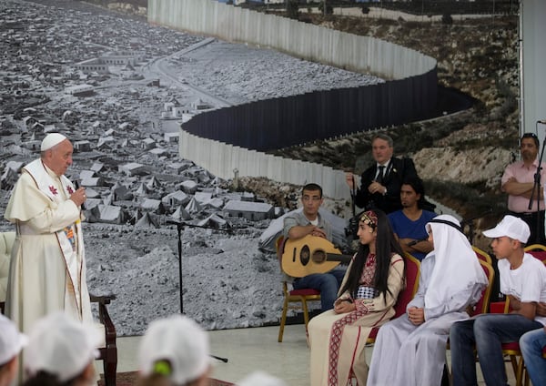 FILE - Pope Francis meets children in the Phoenix Center of the Dheisheh refugee camp, near the West Bank town of Bethlehem, Sunday, May 25, 2014. (AP Photo/Andrew Medichini, Pool, File)