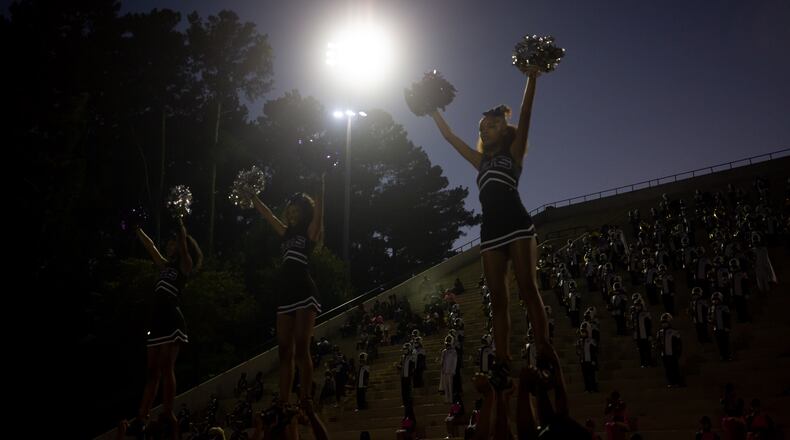 Cheerleaders raise their pom poms during a GHSA high school football game between Stephenson High School and Miller Grove High School at James R. Hallford Stadium in Clarkston, GA., on Friday, Oct. 8, 2021. (Photo/Jenn Finch)