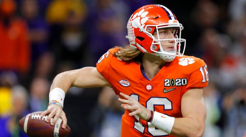 FILE - Clemson quarterback Trevor Lawrence passes against LSU during the second half of a NCAA College Football Playoff national championship game in New Orleans, in this Monday, Jan. 13, 2020, file photo. Ohio State quarterback Justin Fields was among 98 juniors granted eligibility by the NFL into the draft, while national championship-winning QBs Mac Jones from Alabama and Trevor Lawrence from Clemson were among another 30 players eligible after completing their degrees and deciding not to play more in college. (AP Photo/Gerald Herbert, File)