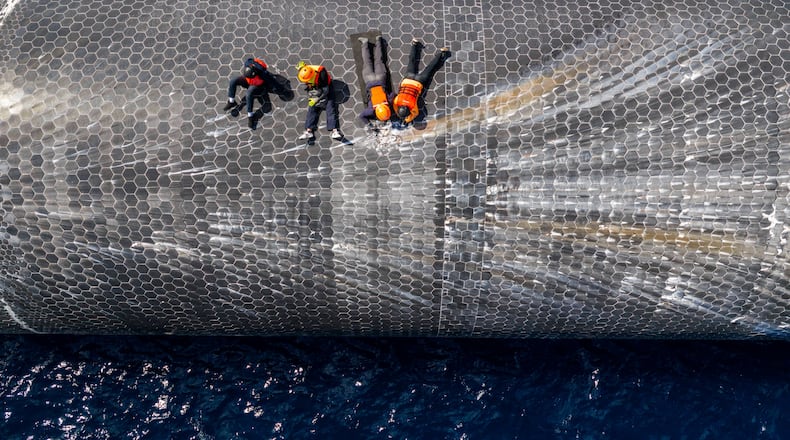 This image provided by SpaceX on Aug. 27, 2026, shows engineers inspecting Starship off the coast of Christmas Island in the Indian Ocean, following its launch on a test flight back in July. (SpaceX via AP)