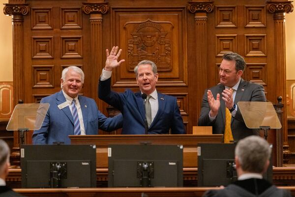Gov. Brian Kemp, between Speaker Jon Burns and Lt. Gov. Burt Jones, waves after his final State of the State speech in the House of Representatives at the Capitol in Atlanta on Thursday, Jan. 15, 2026. (Arvin Temkar/AJC)