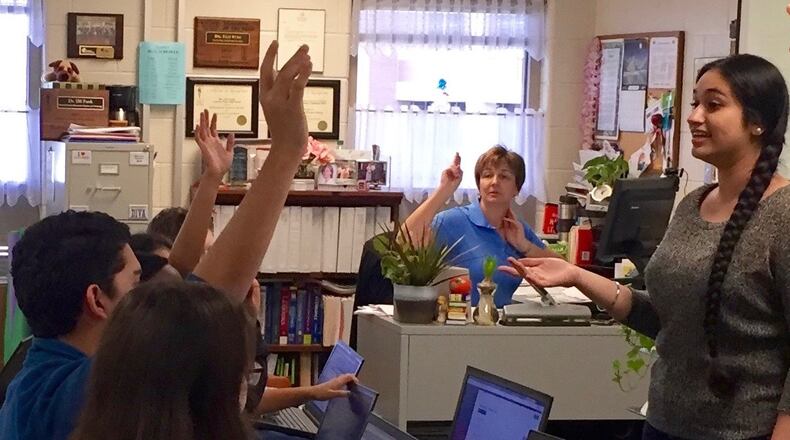 Devneet Singh (far right) leads a tax preparation class of students at The Gwinnett School of Math, Science, and Technology. Dr. Elfi Funk, who sponsors the students, looks on. ESTHER ASARE-NKANSAH