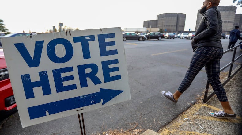 A person walks outside of the Voter Registration and Elections Office in Dekalb County during of the first day of early voting on Monday, March 2, 2020.