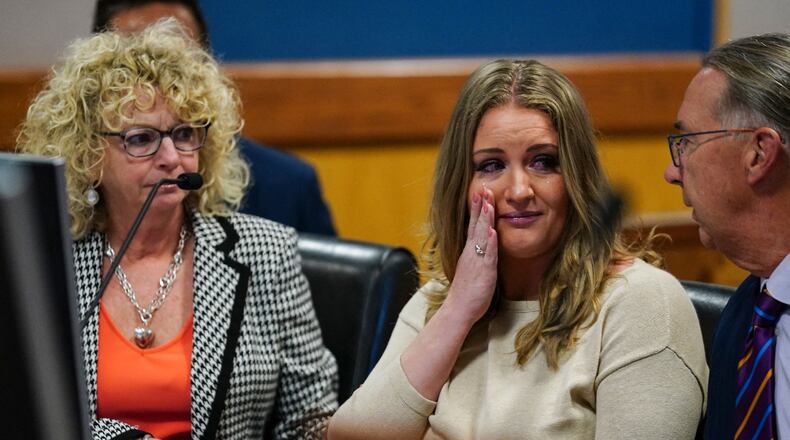Jenna Ellis reacts with her lawyers after reading a statement pleading guilty to one felony count of aiding and abetting false statements and writings inside Fulton Superior Court Judge Scott McAfee's Fulton County Courtroom in Atlanta, on Oct. 24, 2023. (John Bazemore/Pool/AFP/Getty Images/TNS)