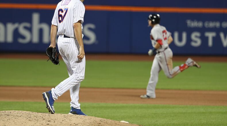 The Braves' Austin Riley circles the bases after his home run off the Mets' Seth Lugo (left).  (Photo by Al Bello/Getty Images)