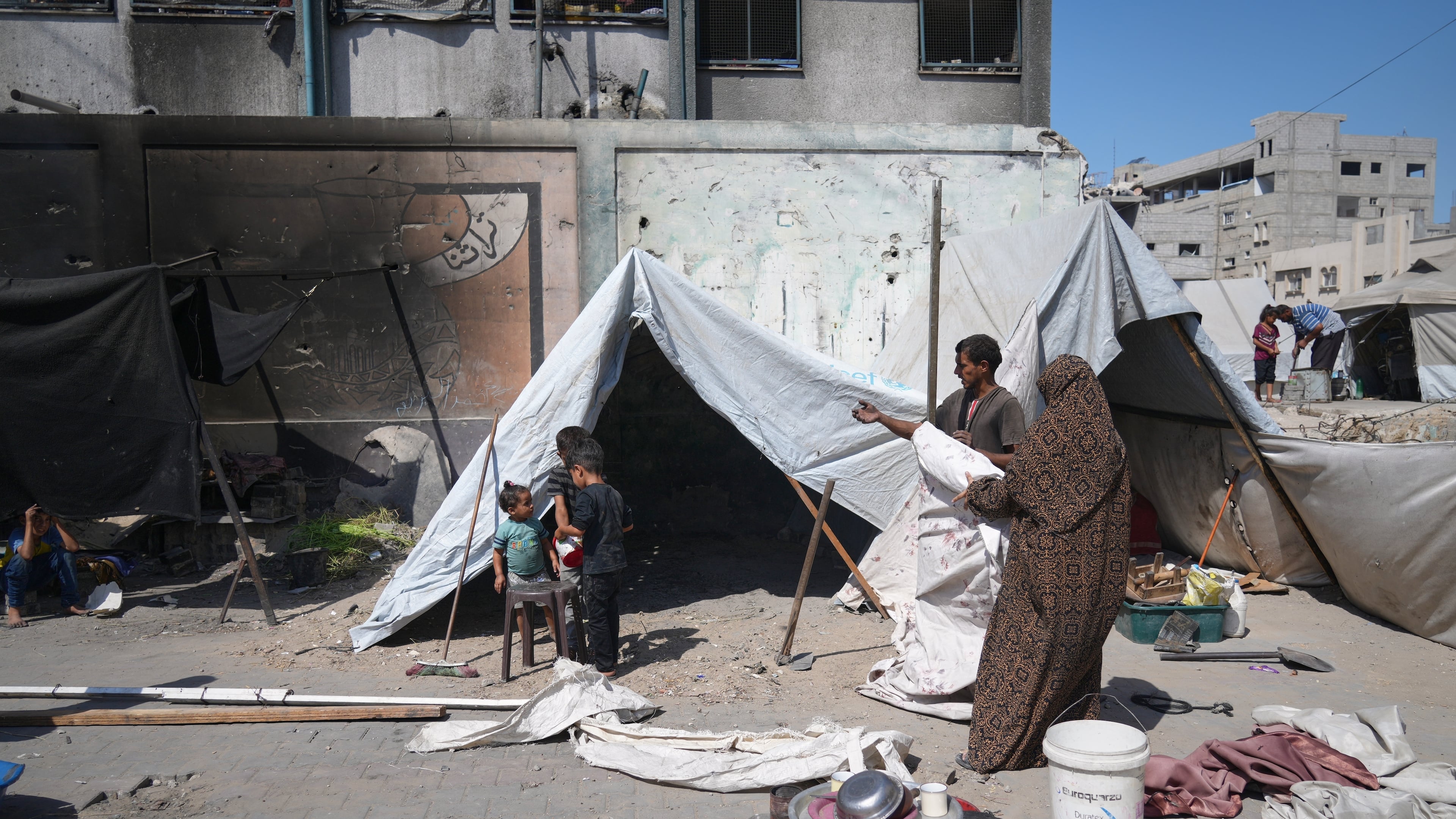 A family sets up a tent near a UN school used as a shelter for displaced Palestinians in Khan Younis, Tuesday, Sept 30, 2025. (AP Photo/Jehad Alshrafi)