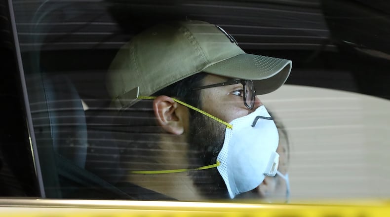 File photo of a man waiting at a drive-through COVID testing site.(Curtis Compton/AJC)