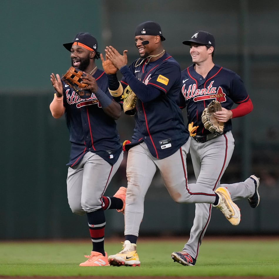 Atlanta Braves center fielder Michael Harris II, left, right fielder Ronald Acuña Jr., center, and left fielder Mike Yastrzemski celebrate after winning a baseball game against the Houston Astros in Houston, Saturday, Sept. 19, 2026. (AP Photo/Ashley Landis)