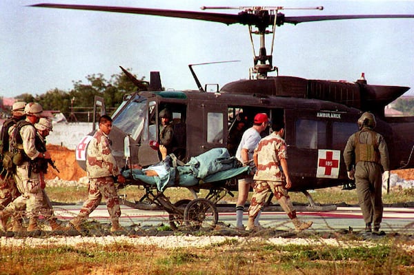 U.S. helicopter pilot Michael Durant is carried on a stretcher to the helicopter from the 46th Combat Support hospital. (Hocine Zaourar/AFP via Getty Images 1993)