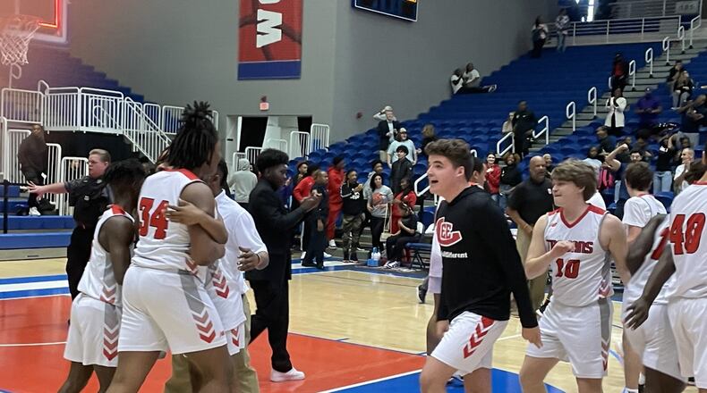 Lee County players celebrate their 49-48 victory over Lanier in the Class 6A basketball semifinals at the University of West Georgia on March 4, 2023.