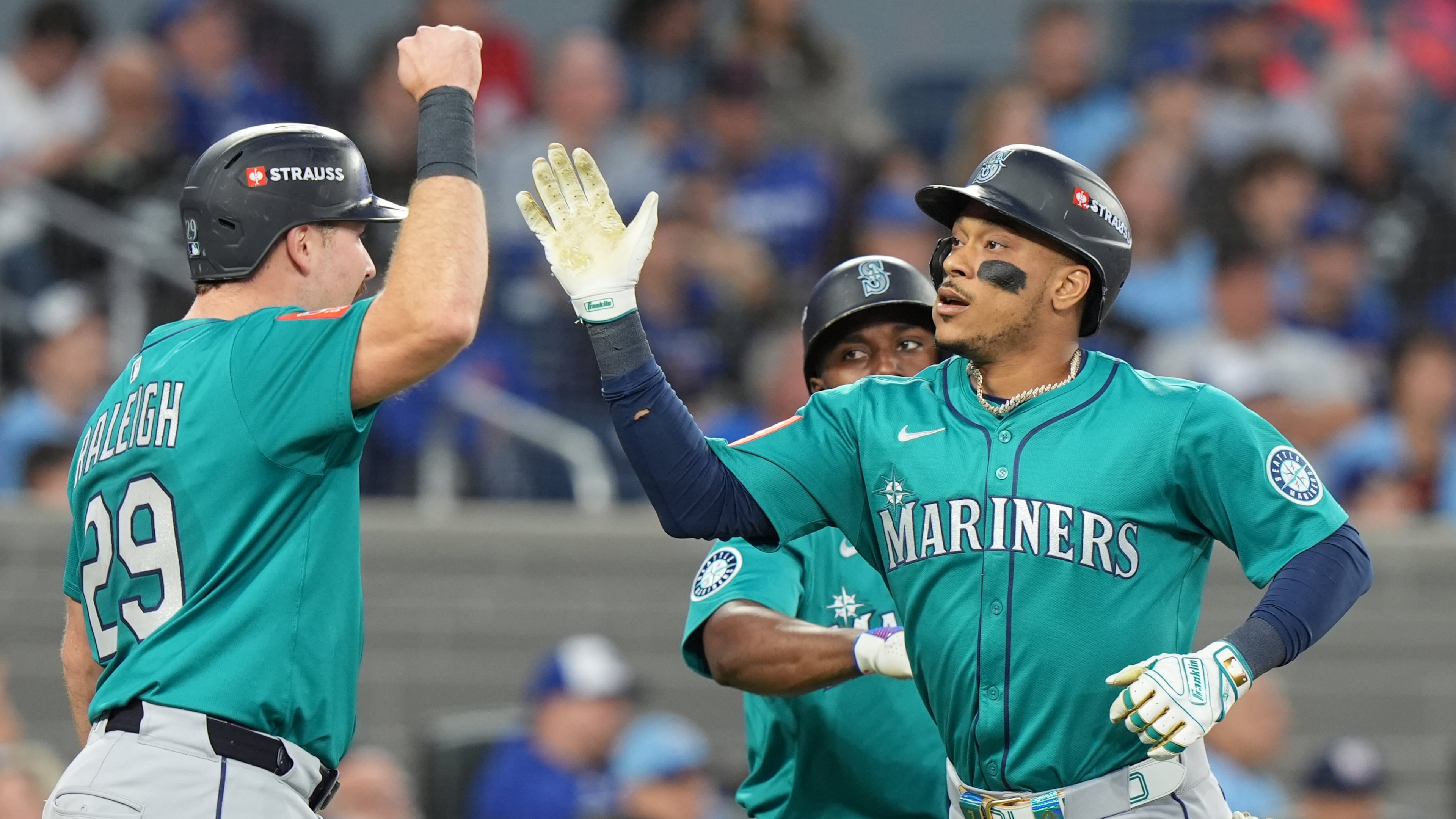 Seattle Mariners' Jorge Polanco, right, celebrates after his a three-run home run with Cal Raleigh (29) during the fifth inning of Game 2 of baseball's American League Division Series against the Toronto Blue Jays in Toronto, Monday, Oct. 13, 2025. (Frank Gunn/The Canadian Press via AP)