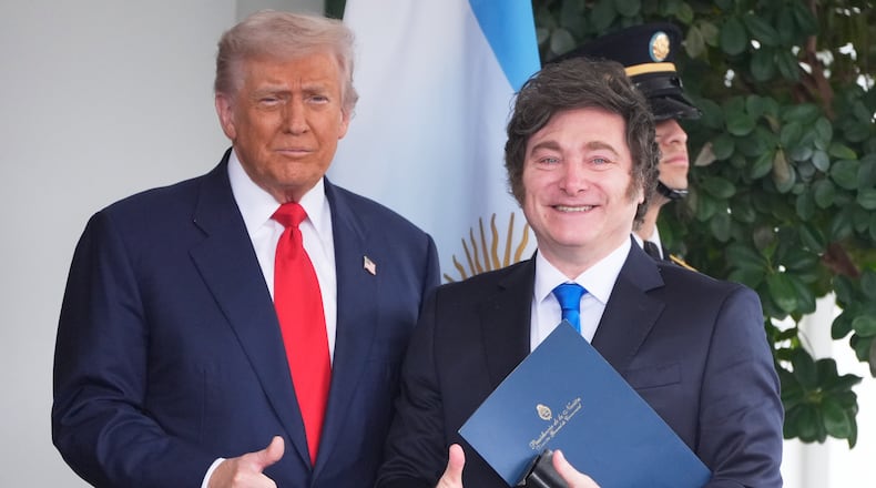 President Donald Trump greets Argentina's President Javier Milei, as he arrives at the White House, Tuesday, Oct. 14, 2025, in Washington. (AP Photo/Mark Schiefelbein)