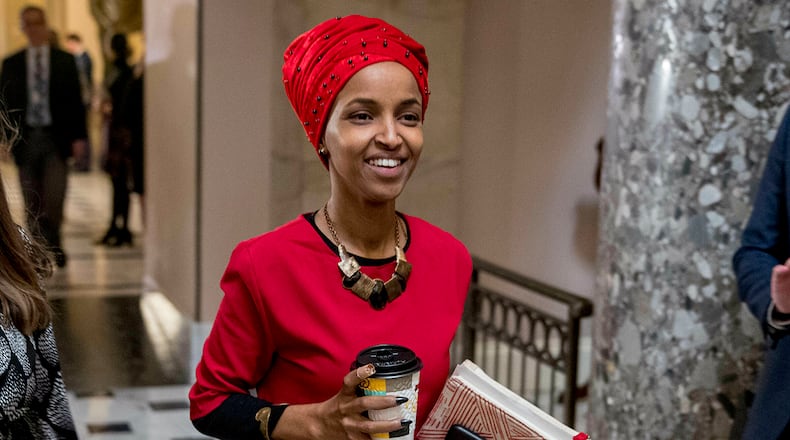 In this Jan. 16, 2019 file photo, Rep. Ilhan Omar, D-Minn., center, walks through the halls of the Capitol Building in Washington. (AP Photo/Andrew Harnik)