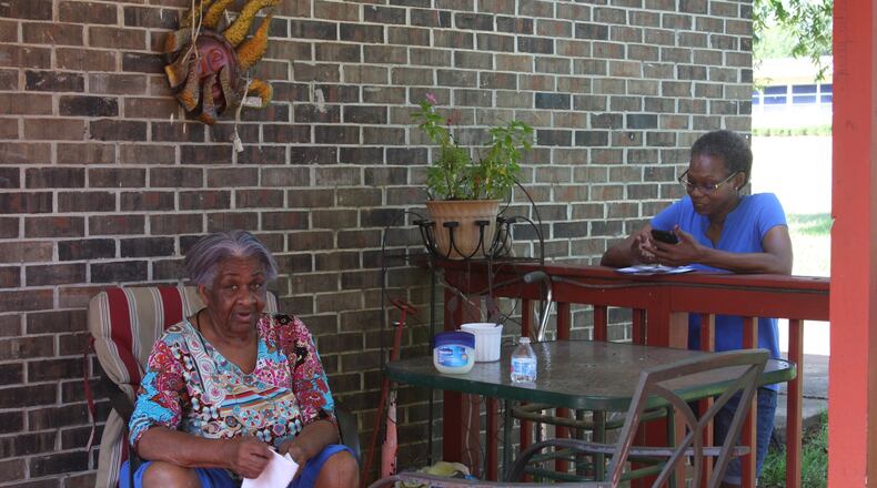 Carolyn Baker, right, speaks with Mildred Thornton of Cuthbert while canvassing for Democrat Stacey Abrams’ campaign for governor. Black rural voters could be crucial to Abrams’ effort in a tight race with Republican Brian Kemp.
