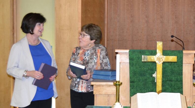 Tracy Crump (left), president and CEO of the Foundation of Wesley Woods, talks about the senior living nonprofit’s new pastoral care program with Wesley Woods Towers resident Karen Lindauer. DAN CURRAN
