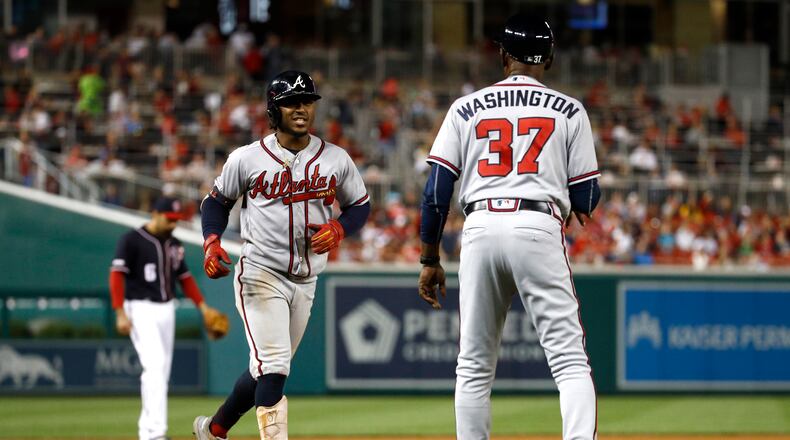 Atlanta Braves' Ozzie Albies, left, rounds the bases past third base coach Ron Washington after hitting a solo home run during the seventh inning of the team's baseball game against the Washington Nationals, Friday, Sept. 13, 2019, in Washington. Atlanta won 5-0. (AP Photo/Patrick Semansky)