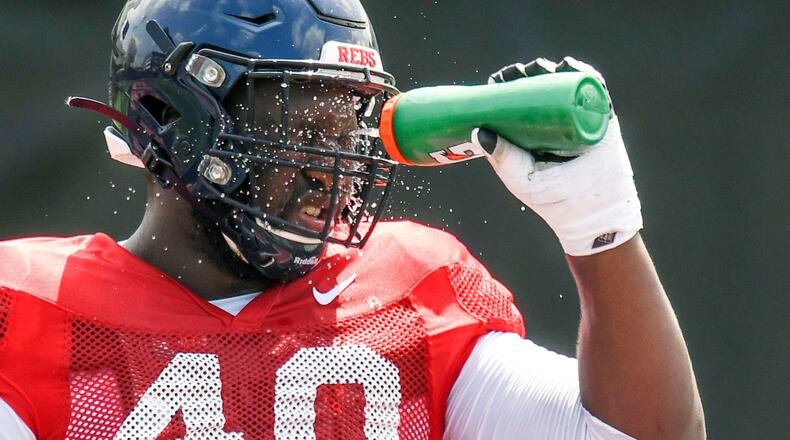 Mississippi's Josiah Coatney cools off during football practice in Oxford, Miss., Wednesday, Aug. 7, 2019. The defensive tackle from Douglasville, Ga., is looking to impress NFL scouts at the 2020 Senior Bowl.