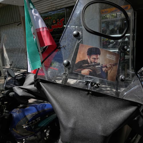 A poster is pasted on a motorbike windshield with graphic depicting Iran's Supreme Leader Ayatollah Mojtaba Khamenei as government supporters gather to mark the 40th day since the killing of his father, Supreme Leader Ayatollah Ali Khamenei, in Tehran, Iran, Thursday, April 9, 2026. (AP Photo/Vahid Salemi)